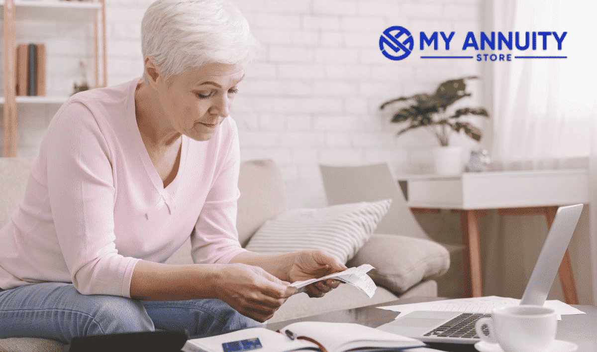 2021 rmd requirements q&aretired woman in pink sweater working on finances in living room