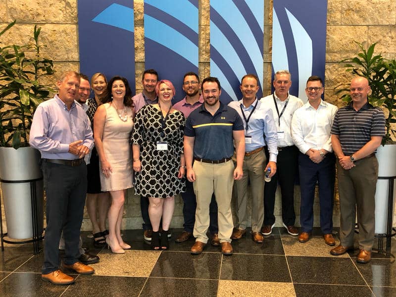 Jason caudil and athene home office staff in the lobby of athene annuity and life company's headquarters.